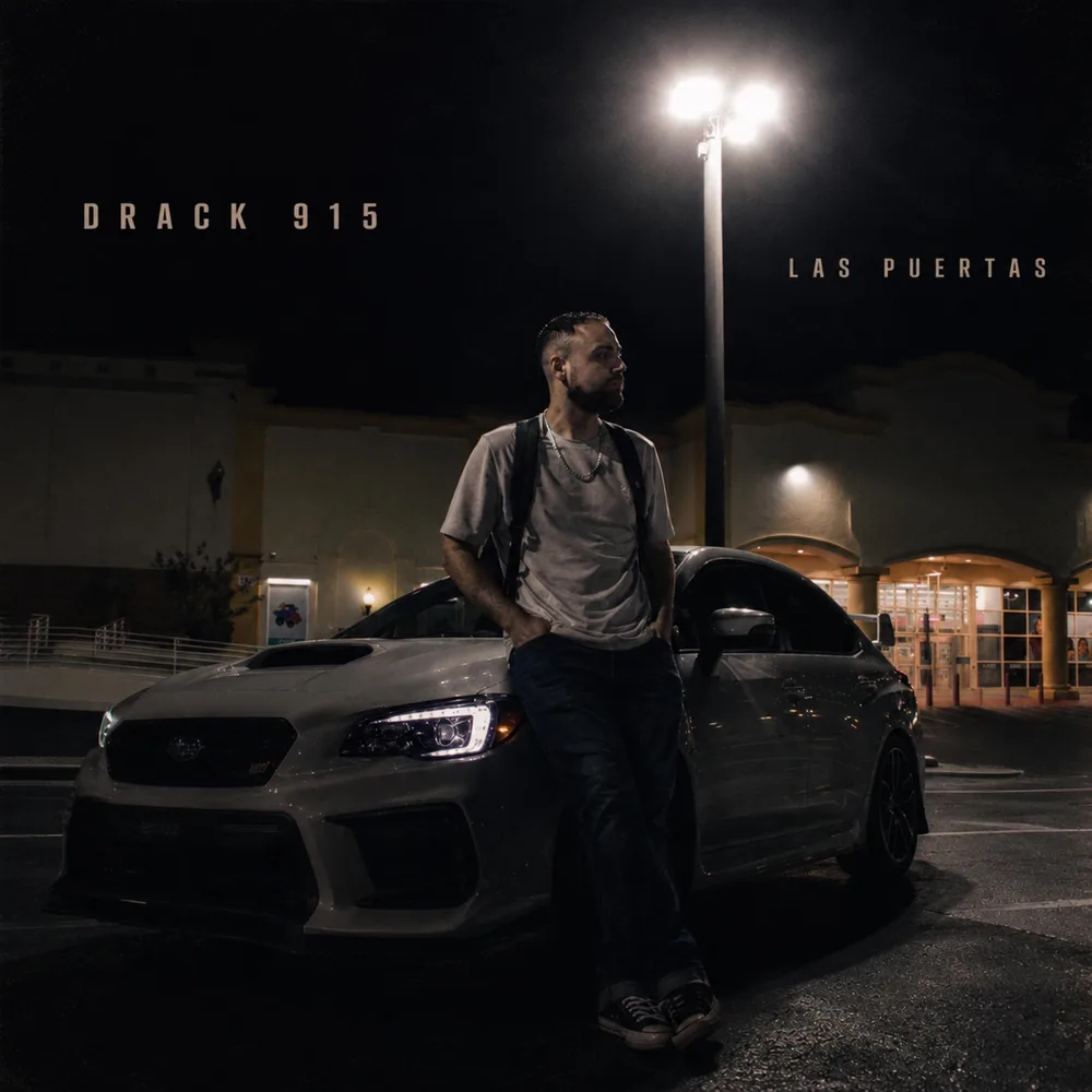 DRACK 915 beside a car in a Yozakura parking lot at night